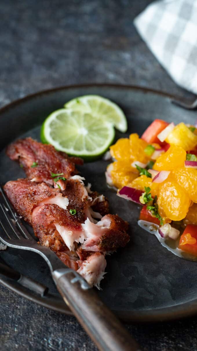 Plate with fish and colorful citrus salsa.