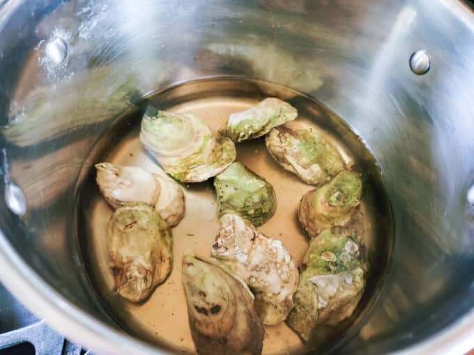 Oysters placed in boiling liquid.