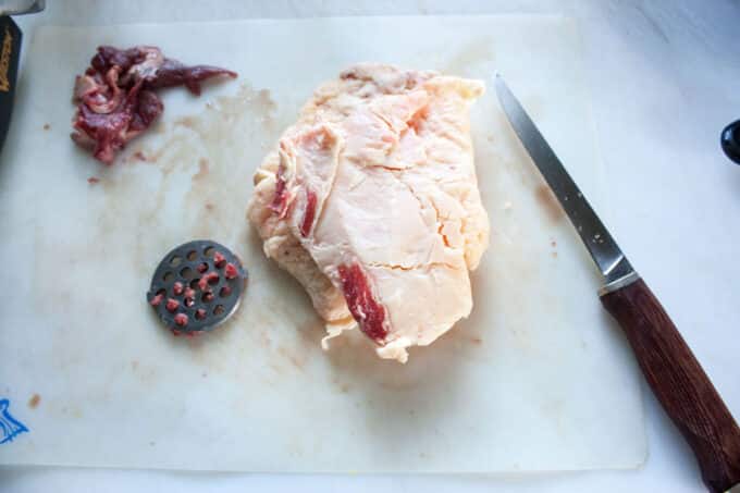 Chunk of beef trimmings on cutting board.