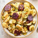 German potato salad in beige bowl.