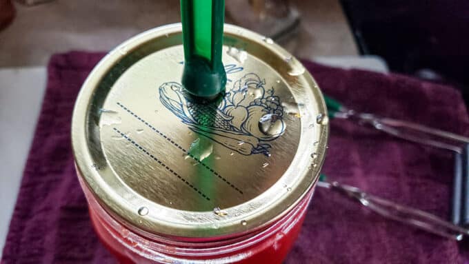 Centered lid placed on jar with lid lifter.