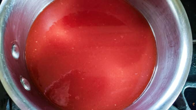 Tomato juice added to another pot to heat.