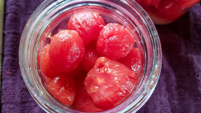 Peeled tomatoes in quart jar.