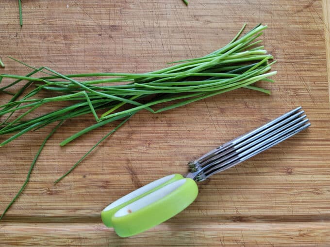 Chives gathered into a bundle with herb shears.