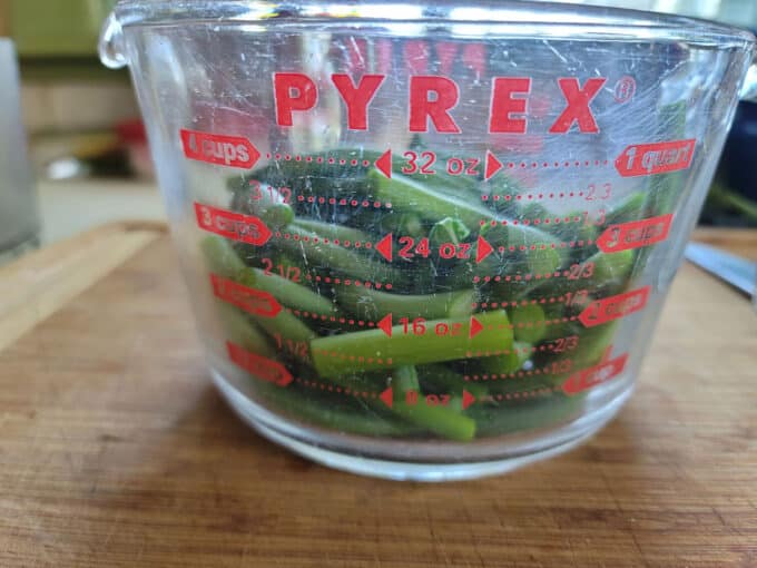 Cut scapes in glass measuring cup.