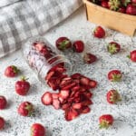 Dried Strawberries spilling from mason jar.