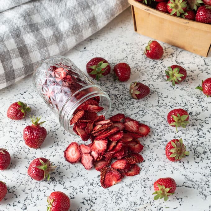Dried Strawberries spilling from mason jar.