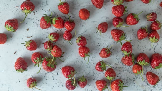 Strawberries on white board.