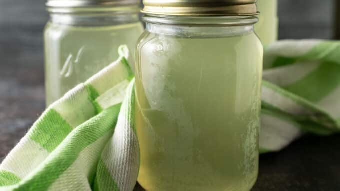 Garlic scape broth in jars.