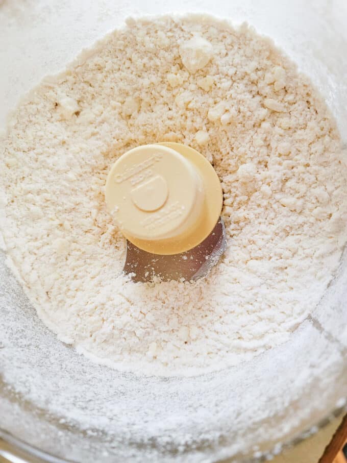 Pulsed flour and butter in food processor bowl.