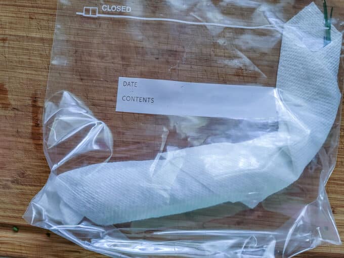 Rolled chives placed into a bag.