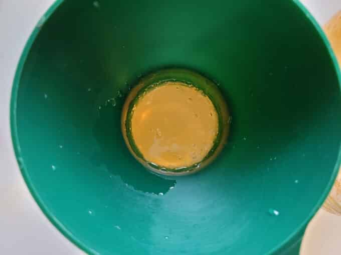 Jelly poured into jars with canning funnel.
