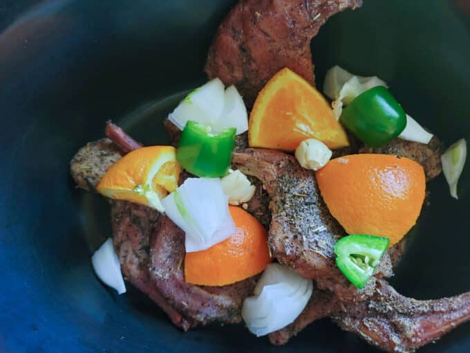 Jalapenos added to crockpot with rabbit.