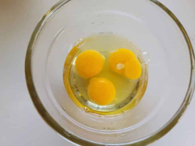 Cracked eggs in bowl.