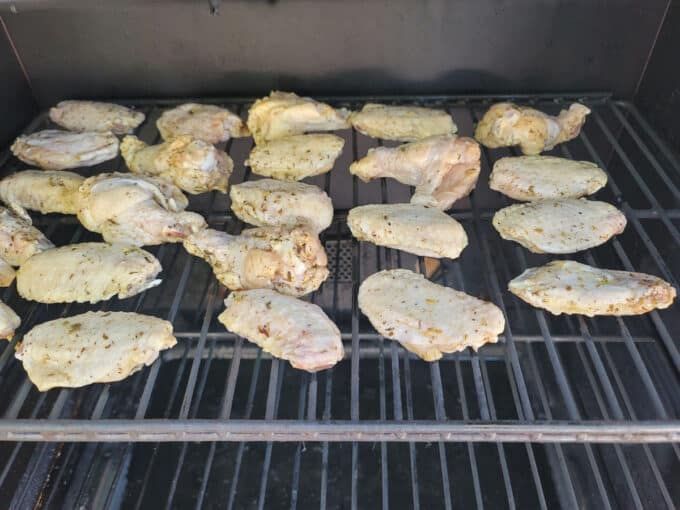 Wings in smoker on rack.