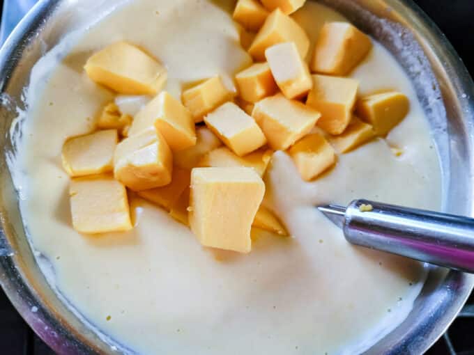 Chunks of Velveeta added to sauce.