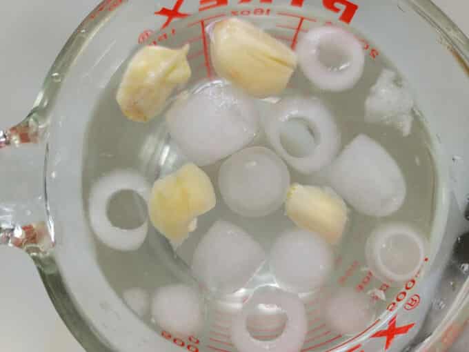 Ice cubes in the brine mix to cool.