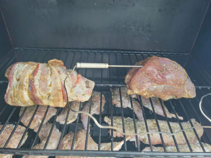 Breasts placed in smoker with thermometer inserted. 