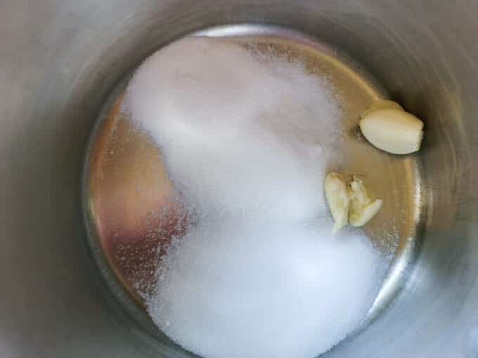 Salt and sugar in a pot with garlic.