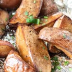 Close up of smoked potatoes on aluminum foil.