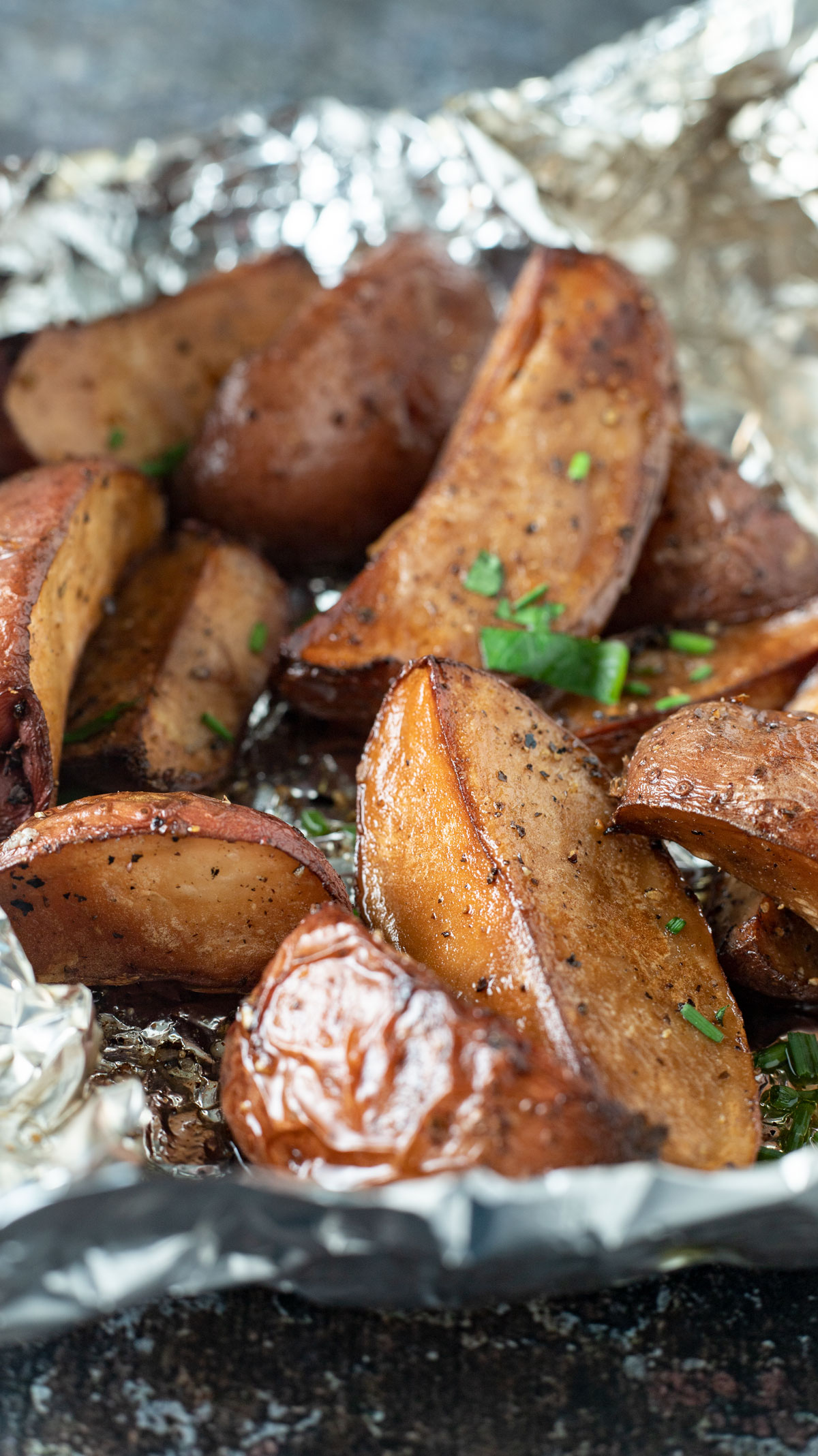 Potato wedges on crinkled foil.