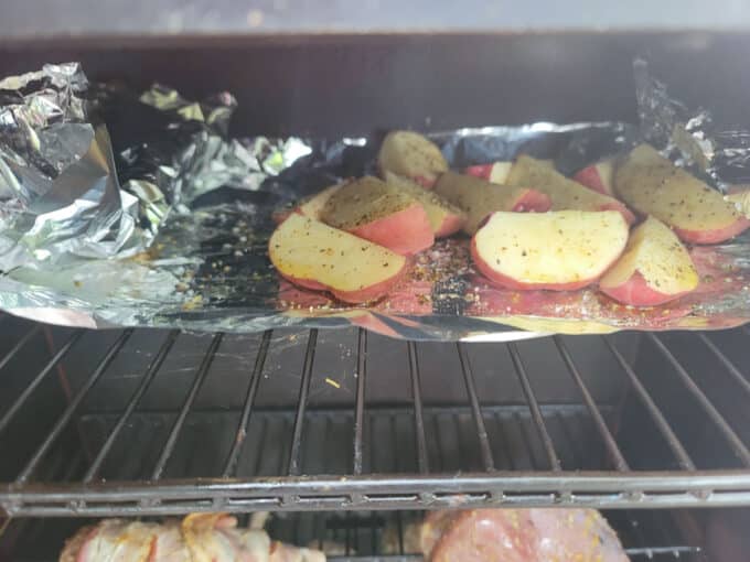 Potatoes on foil in smoker.