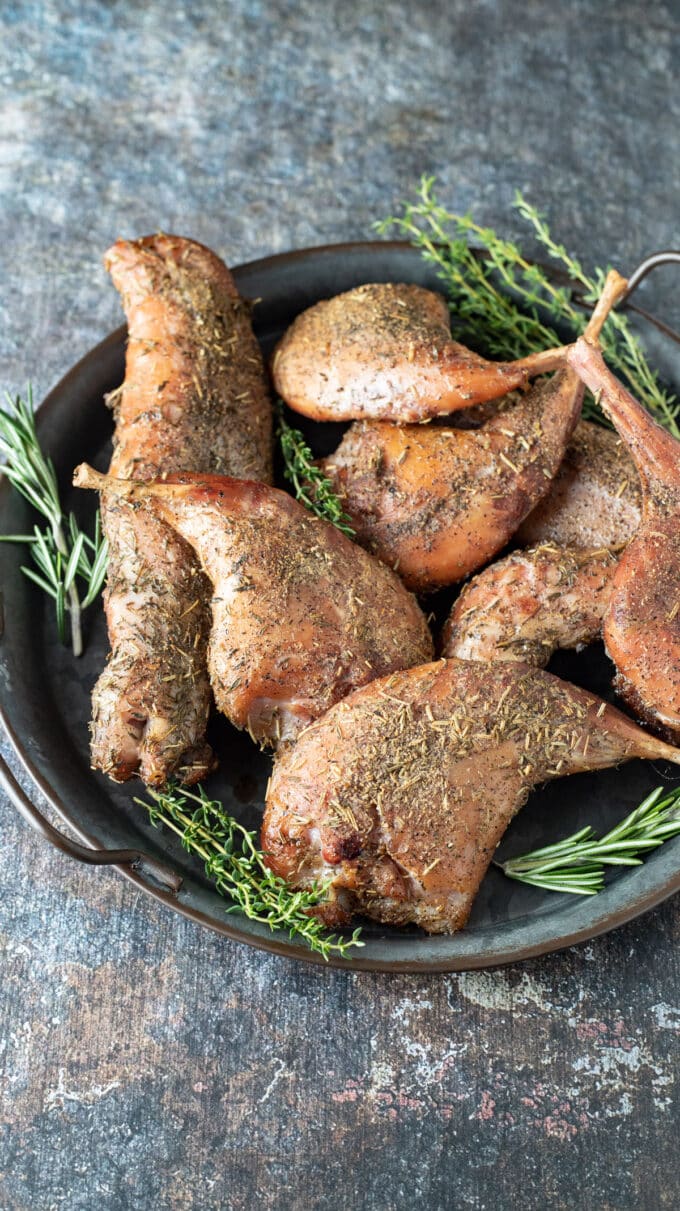 Pieces of rabbit on metal serving tray.