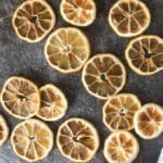 Dried lemon slices on dark background.