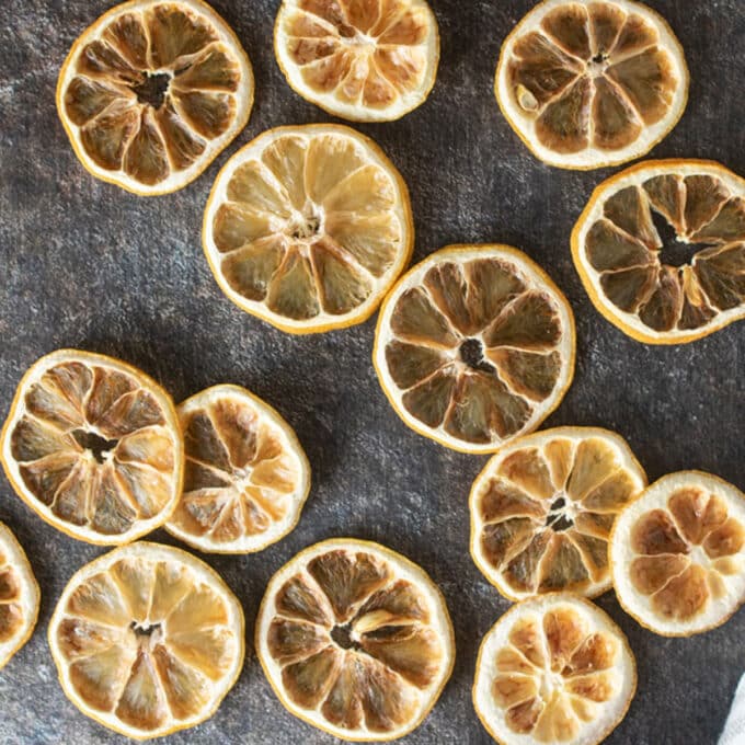 Dried lemon slices on dark background.