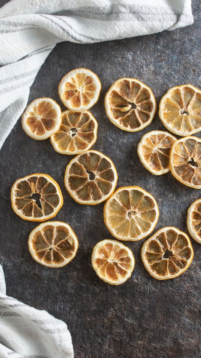 Dehydrated lemons on black board with white towel.