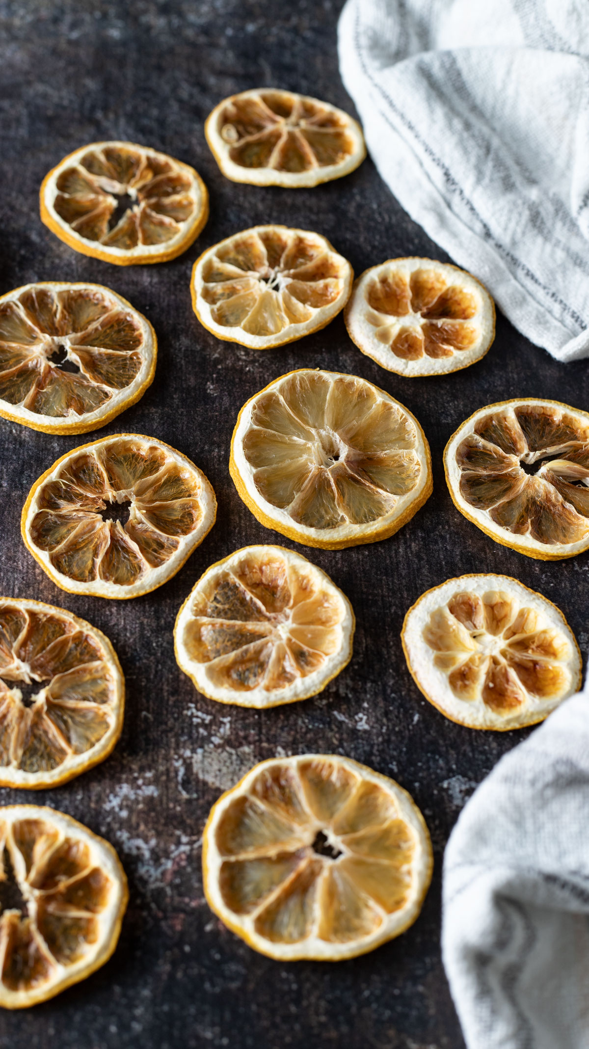 Dehydrated lemon slices on dark background.