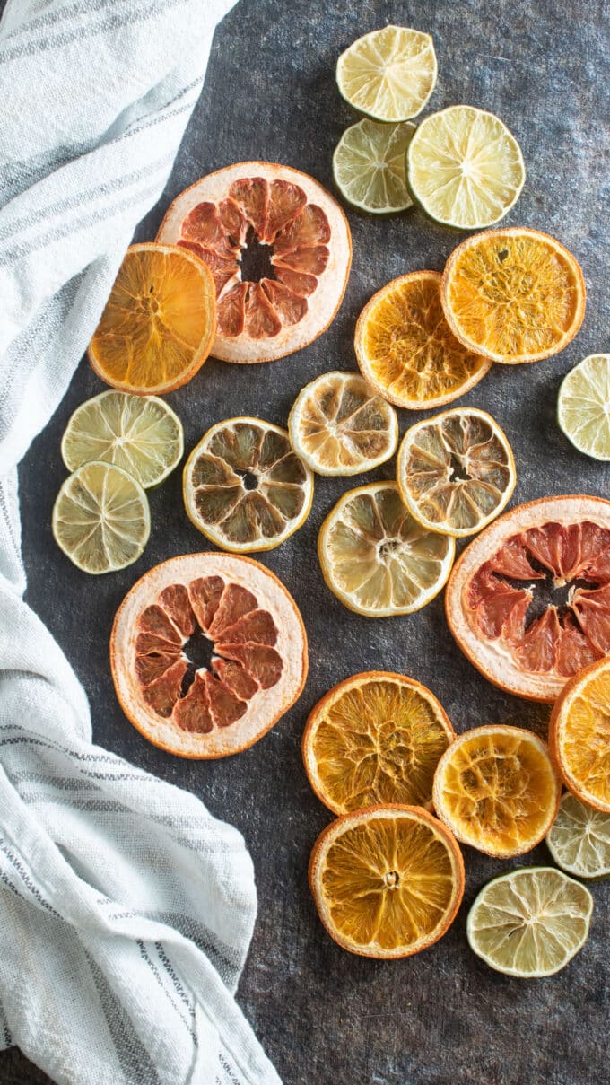 Mixed dried citrus fruits on black background.