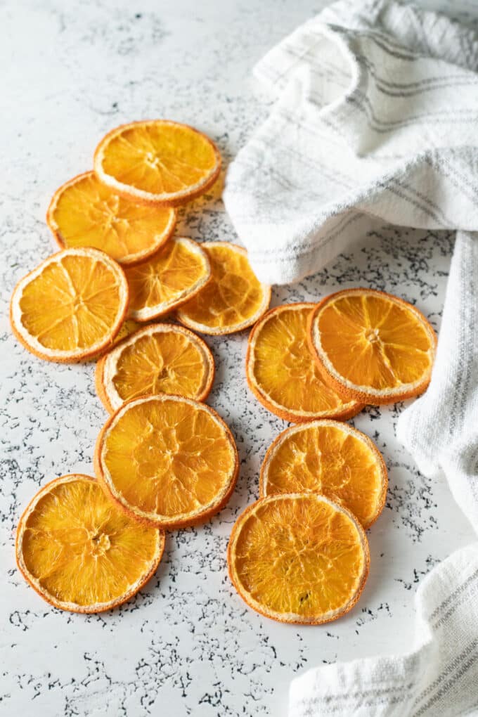 Dried orange slices on white board.