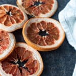 Dried grapefruit slices on dark background.