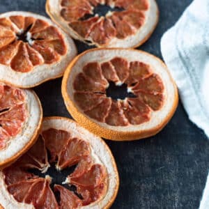 Dried grapefruit slices on dark background.