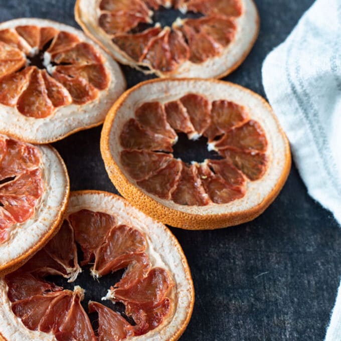 Dried grapefruit slices on dark background.