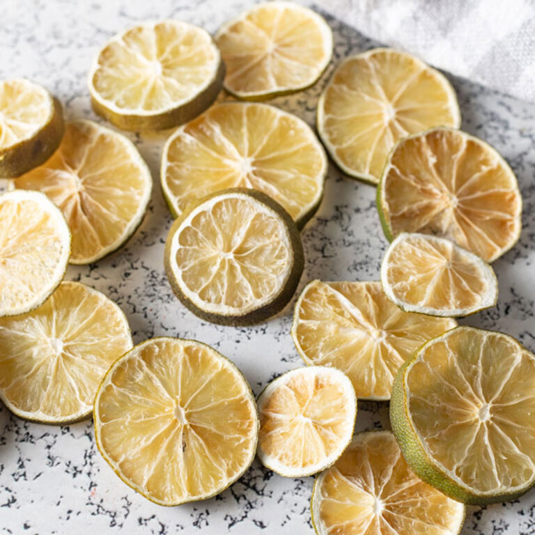 Pile of dehydrated limes on a white background.