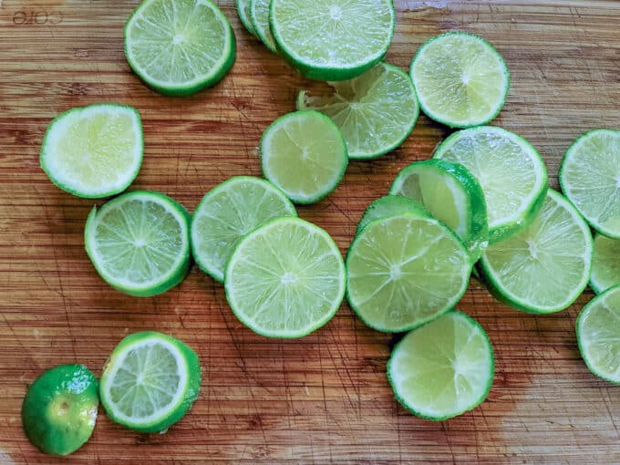 Sliced limes on cutting board.