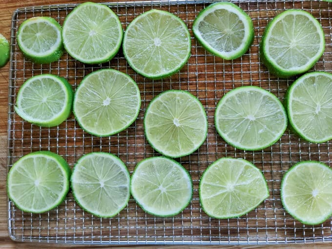 Lime slices arranged on dehydrator rack.