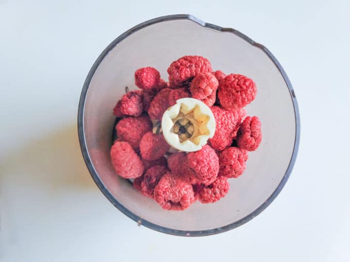 Raspberries in mini food processor bowl.