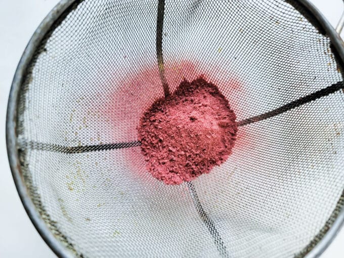 Powder added to fine mesh sieve.