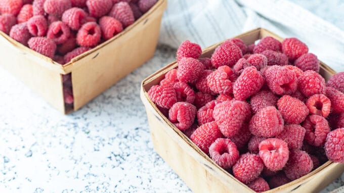 Raspberries in vintage quart containers.