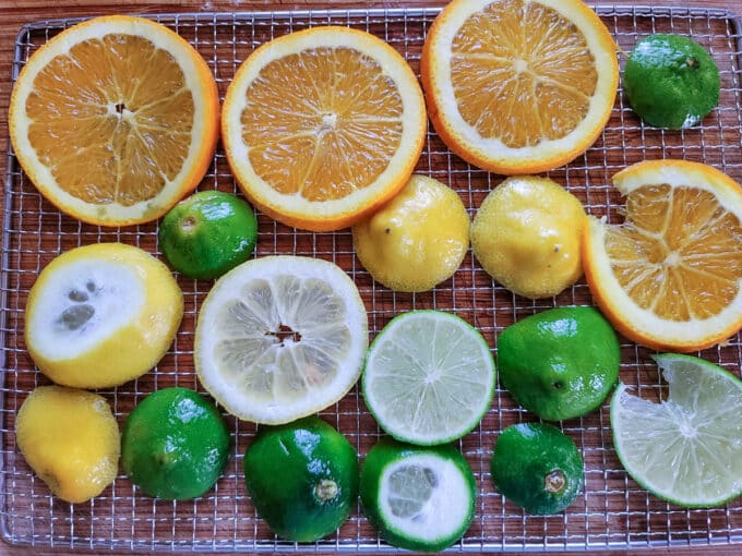 Lemon, orange and lime ends on dehydrator rack.