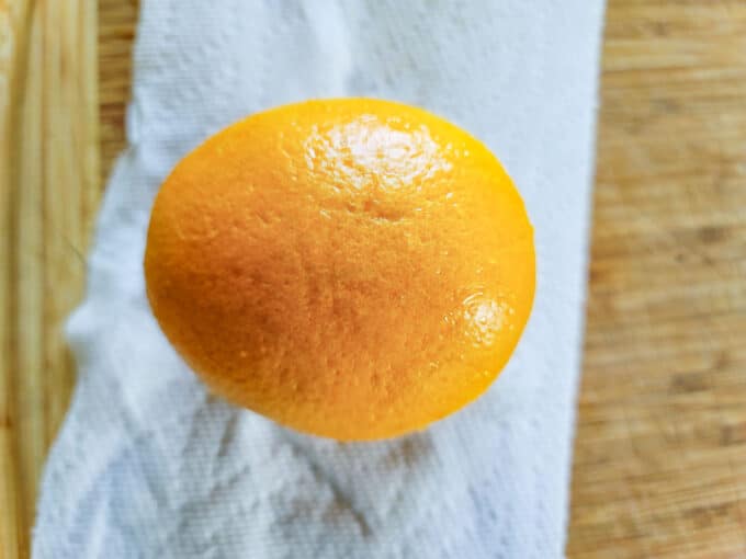 Whole orange on paper towel.