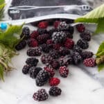 Frozen blackberries on marble board.