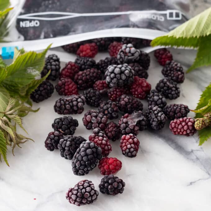 Frozen blackberries on marble board.