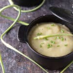 Garlic scape soup in cast iron bowls.