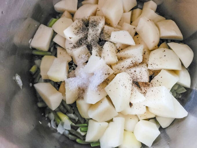 Potatoes, spices added to pot.