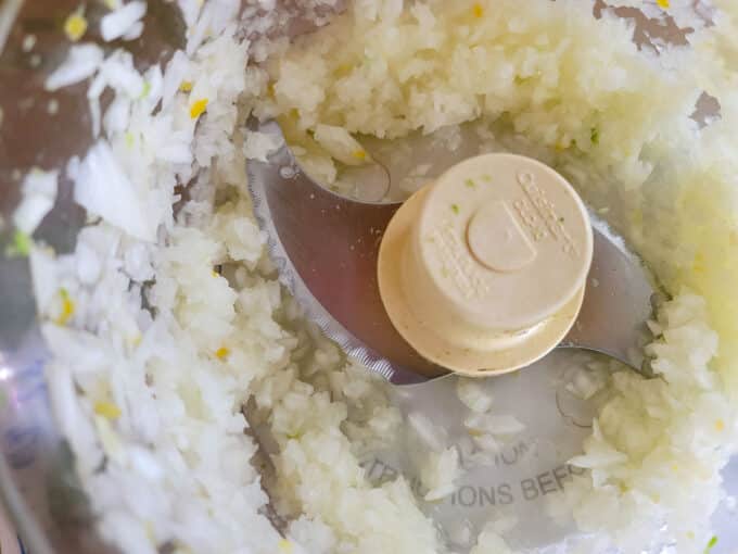 Chopped onions in food processor bowl.