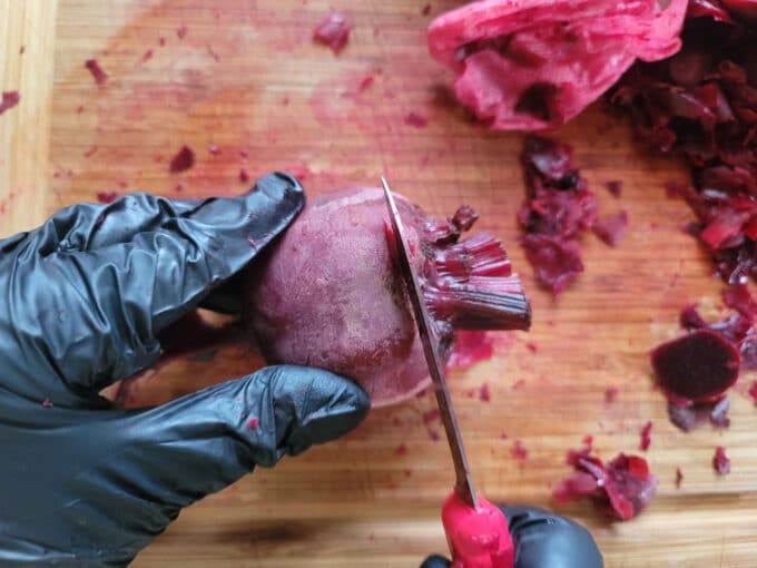 Slicing off the stem end of a beet.